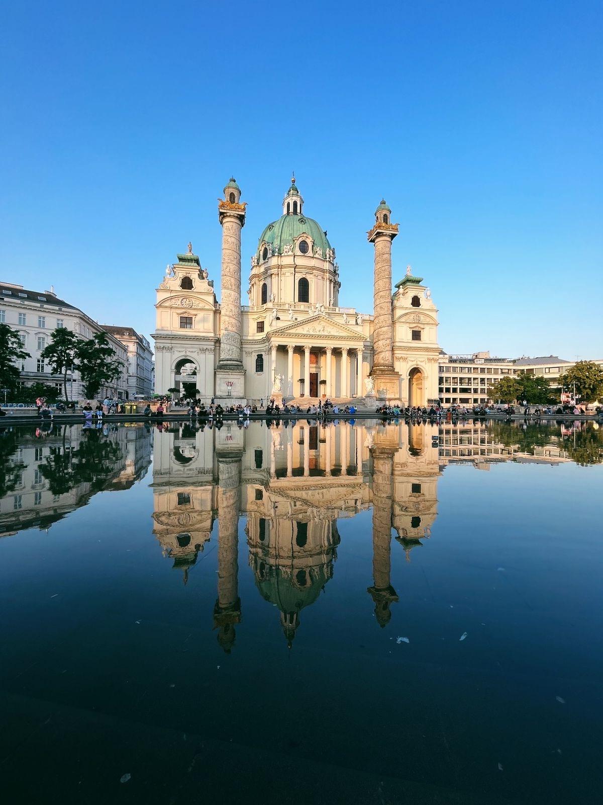 beautiful building in the reflection of a lake